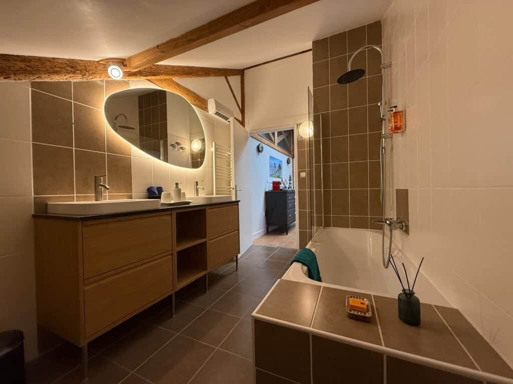 Salle de bain privative avec doubles vasques, baignoire et douche thermostatique dans la Suite l’Estuaire du Château Papounan, chambre d’hôtes de charme à Saint-Estèphe, Médoc.